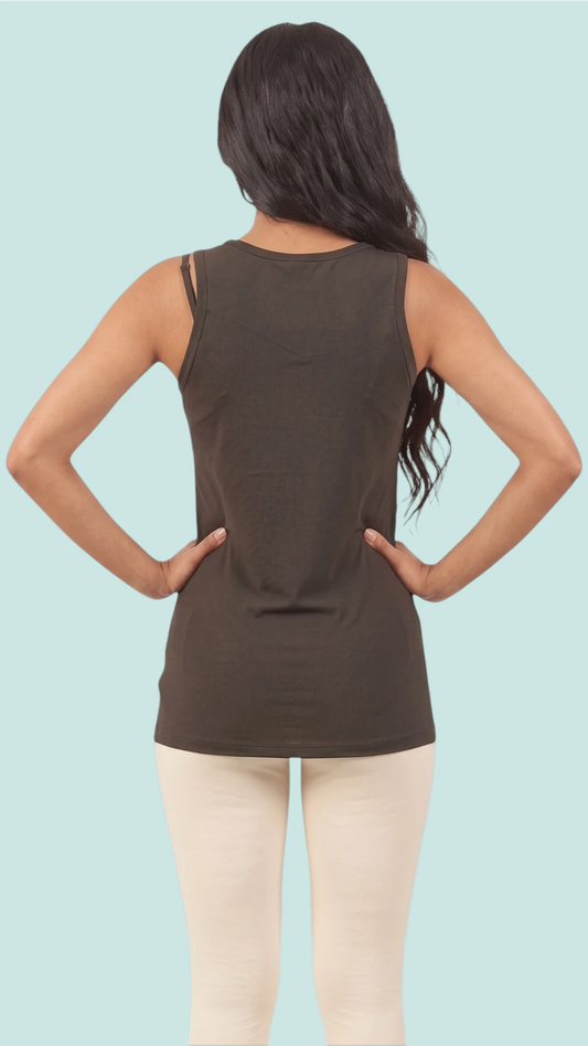 Back view of a woman modeling the Ladybird Line 127 Black Shadow Hair & Bleach Resistant Grooming Tank Top, paired with off-white leggings against a light blue background.