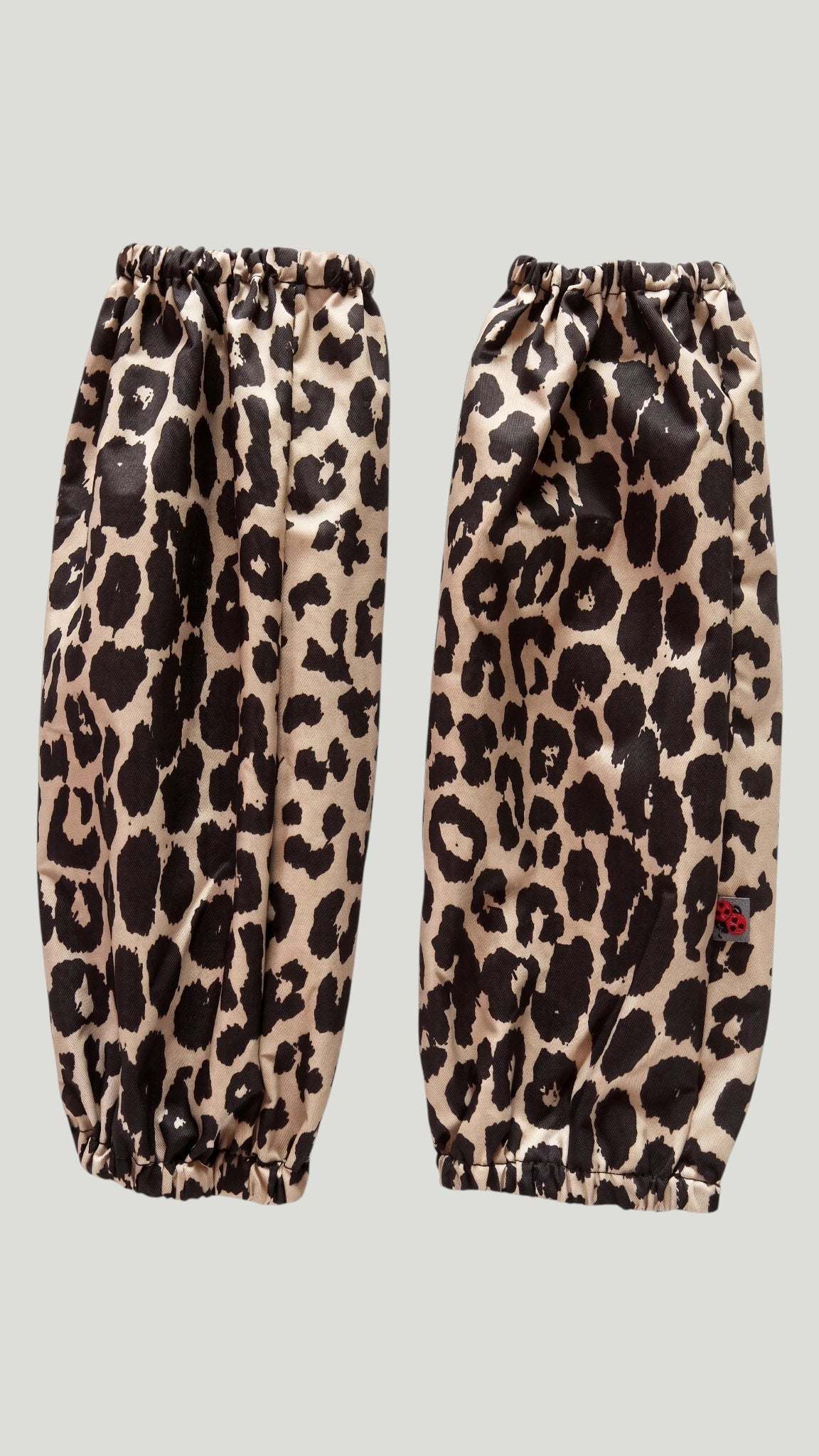 Pair of Ladybird Line 604 waterproof leopard print dog bathing and pet grooming arm sleeves with elastic wrist and arm bands, shown flat against a light gray background.